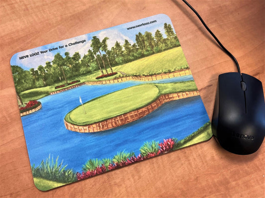 Mousepad featuring a print of the famous 17th hole at TPC Sawgrass, with a golf course, pond, and trees in a serene outdoor landscape.